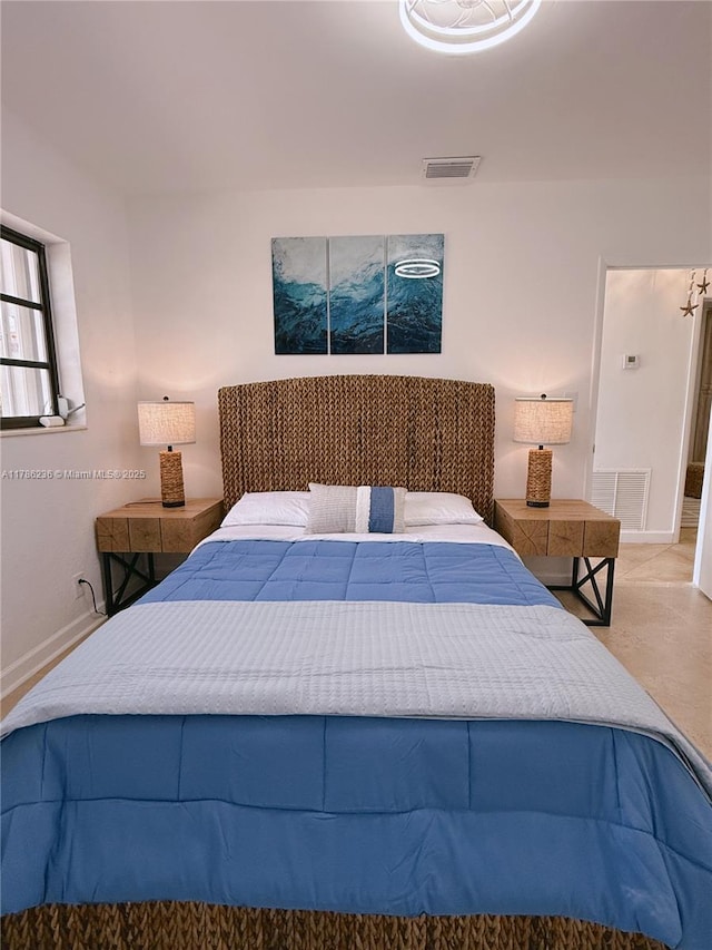 bedroom with baseboards and visible vents
