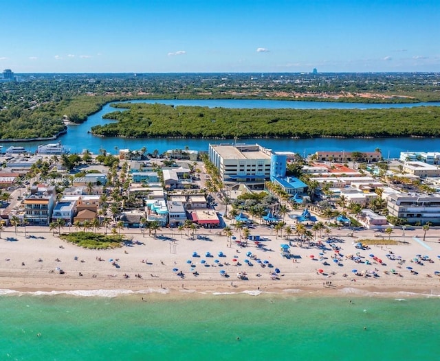 drone / aerial view featuring a water view and a view of the beach