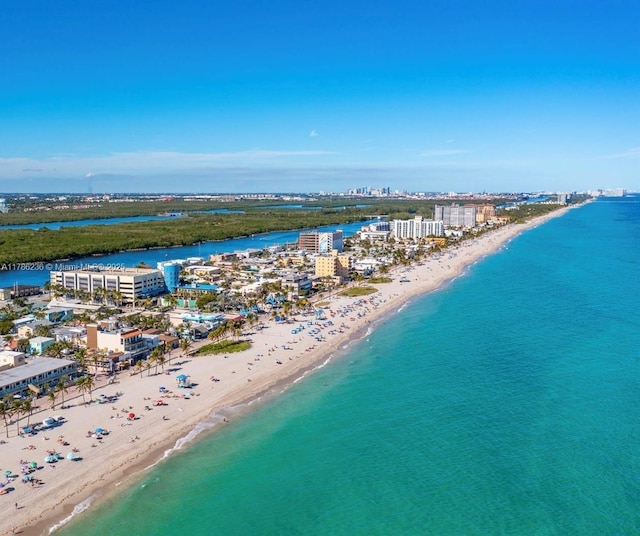 bird's eye view featuring a water view, a city view, and a beach view