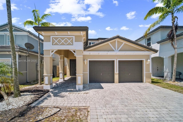 146 NE 36th Ter, Homestead, FL 33033 - view of front of house with a garage, stucco siding, and decorative driveway