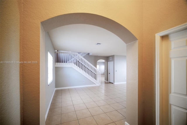 146 NE 36th Ter, Homestead, FL 33033 - interior space with arched walkways, a textured wall, tile patterned floors, and baseboards