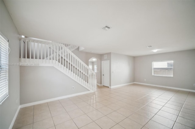 146 NE 36th Ter, Homestead, FL 33033 - interior space with arched walkways, baseboards, visible vents, stairs, and light tile patterned floors