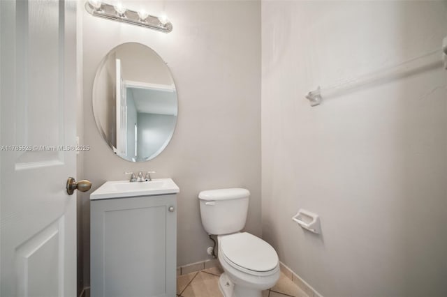 146 NE 36th Ter, Homestead, FL 33033 - half bathroom with baseboards, tile patterned flooring, vanity, and toilet