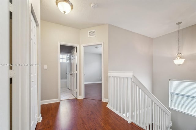 146 NE 36th Ter, Homestead, FL 33033 - hall featuring baseboards, wood finished floors, an upstairs landing, and visible vents