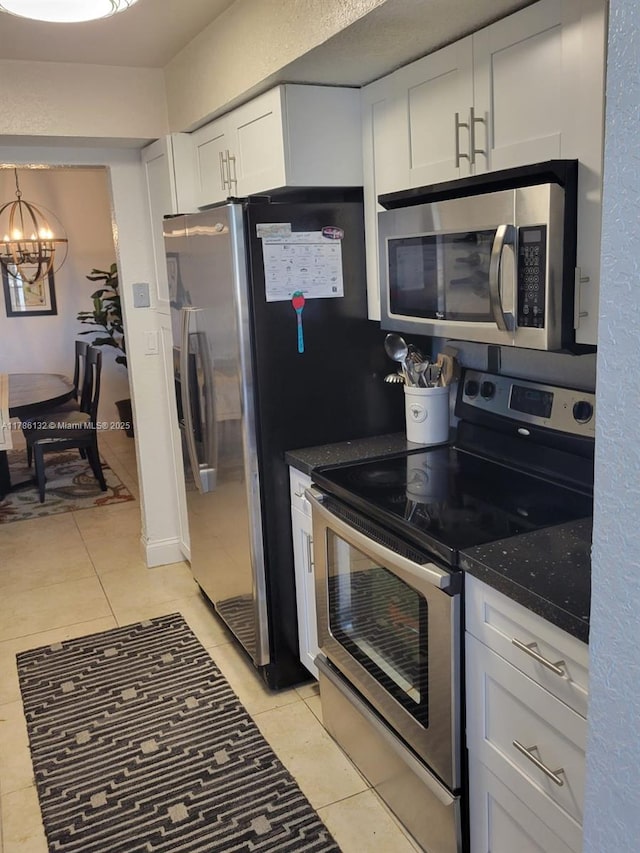 9411 SW 4th St Unit 203, Miami, FL 33174 - kitchen with appliances with stainless steel finishes, light tile patterned floors, a chandelier, white cabinetry, and dark stone counters