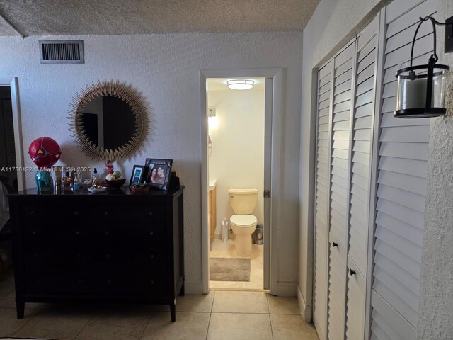 9411 SW 4th St Unit 203, Miami, FL 33174 - corridor featuring light tile patterned floors and a textured ceiling