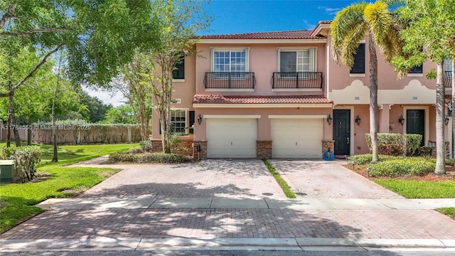 294 Las Brisas Cir, Sunrise, FL 33326 - view of front of home with stucco siding, a tile roof, decorative driveway, a garage, and a balcony