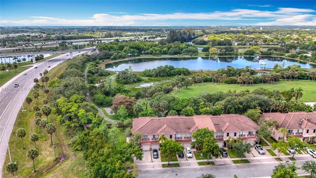 294 Las Brisas Cir, Sunrise, FL 33326 - aerial view of property and surrounding area featuring a nearby body of water, a tree filled landscape, nearby suburban area, and a main thoroughfare