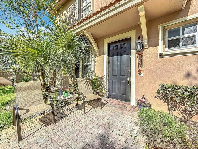 294 Las Brisas Cir, Sunrise, FL 33326 - entrance to property featuring stucco siding and a patio
