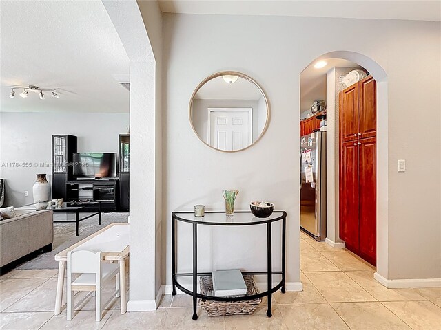 294 Las Brisas Cir, Sunrise, FL 33326 - corridor featuring light tile patterned floors, arched walkways, and baseboards