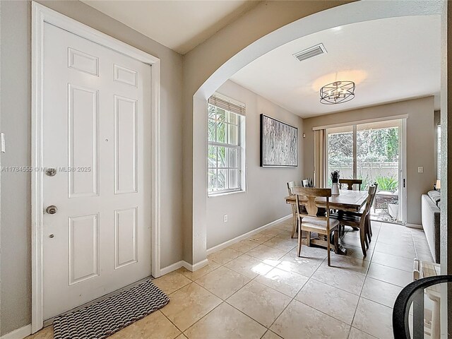 294 Las Brisas Cir, Sunrise, FL 33326 - dining area with arched walkways, light tile patterned floors, and baseboards