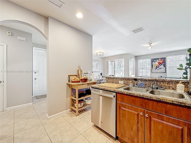 294 Las Brisas Cir, Sunrise, FL 33326 - kitchen with stainless steel dishwasher, arched walkways, a sink, and light tile patterned floors