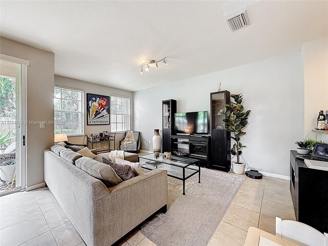 294 Las Brisas Cir, Sunrise, FL 33326 - living room featuring light tile patterned floors, a textured ceiling, baseboards, and track lighting