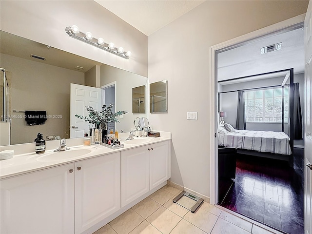 294 Las Brisas Cir, Sunrise, FL 33326 - bathroom featuring double vanity, ensuite bath, tile patterned floors, and baseboards