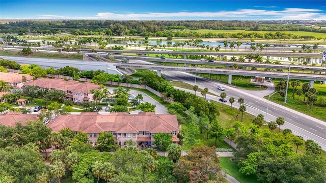 294 Las Brisas Cir, Sunrise, FL 33326 - drone / aerial view of a main thoroughfare, a nearby body of water, and a tree filled landscape
