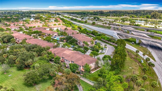 294 Las Brisas Cir, Sunrise, FL 33326 - aerial view of property's location featuring a nearby body of water, nearby suburban area, and a tree filled landscape