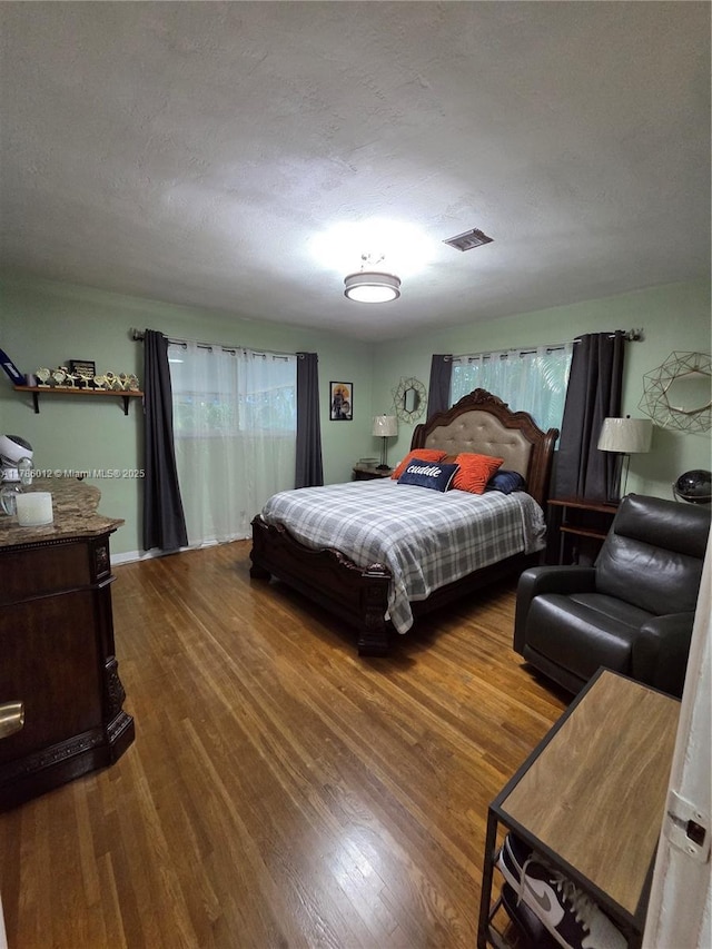 12585 NE Miami Ct, North Miami, FL 33161 - bedroom with visible vents, a textured ceiling, and wood finished floors