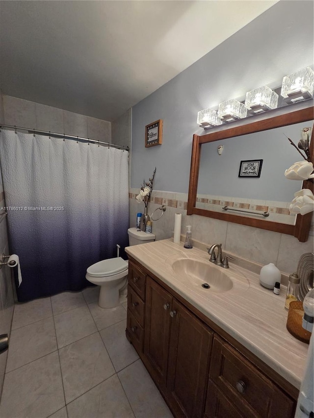 12585 NE Miami Ct, North Miami, FL 33161 - full bathroom featuring tile patterned flooring, vanity, toilet, a wainscoted wall, and tile walls