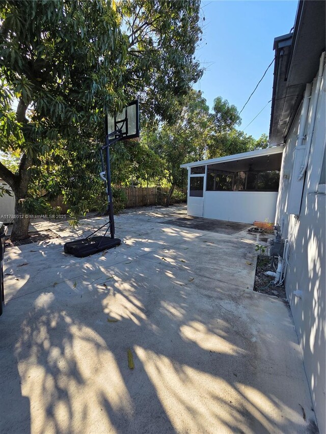 12585 NE Miami Ct, North Miami, FL 33161 - view of patio / terrace with a sunroom and fence