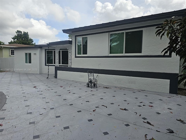 12585 NE Miami Ct, North Miami, FL 33161 - exterior space featuring fence, a patio area, and stucco siding