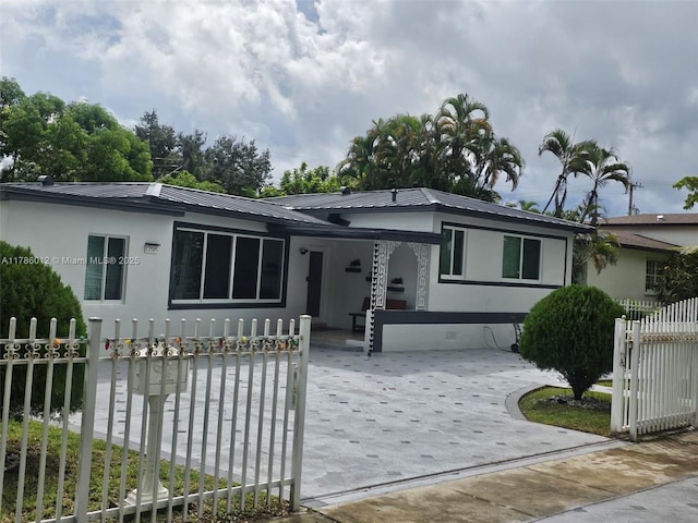 12585 NE Miami Ct, North Miami, FL 33161 - view of front of house with fence private yard and metal roof