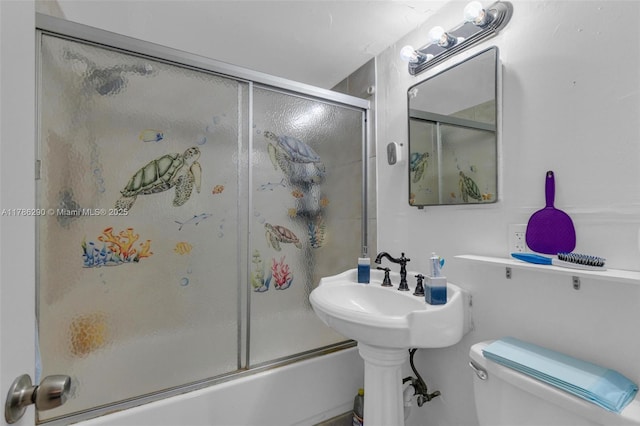 bathroom featuring bath / shower combo with glass door and toilet