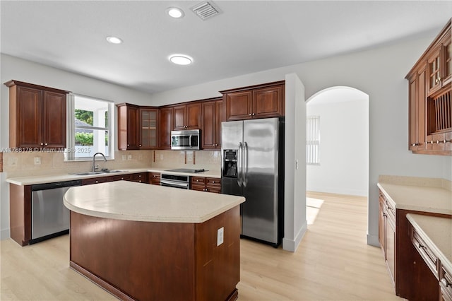 kitchen with light wood-style flooring, appliances with stainless steel finishes, a sink, and visible vents