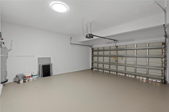 garage with a garage door opener and electric water heater