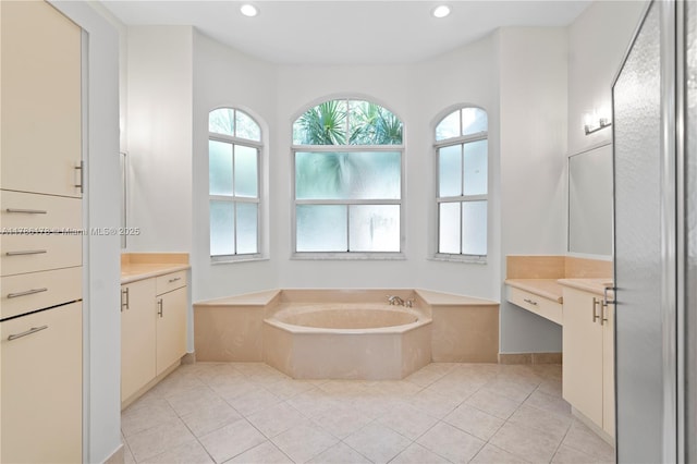 bathroom featuring recessed lighting, tile patterned flooring, a bath, and vanity