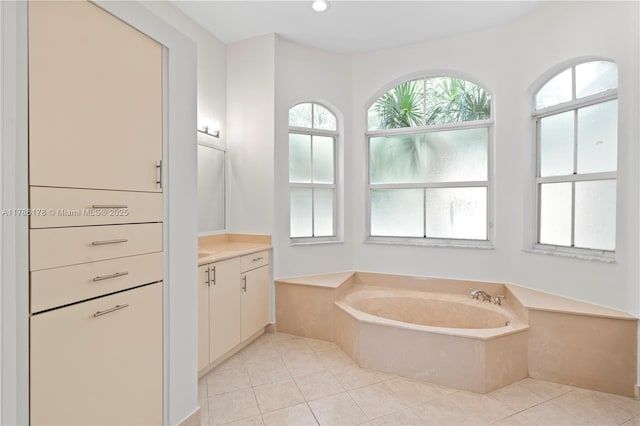 bathroom featuring a garden tub, recessed lighting, tile patterned floors, and vanity