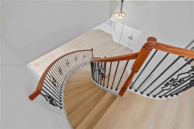 stairway featuring wood finished floors