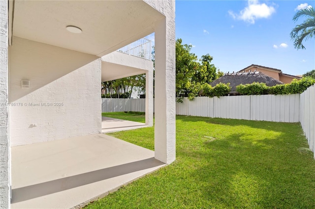 view of yard with a fenced backyard and a patio