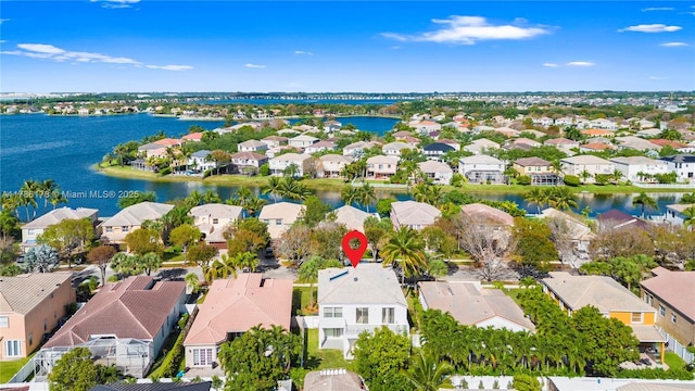 birds eye view of property with a water view and a residential view