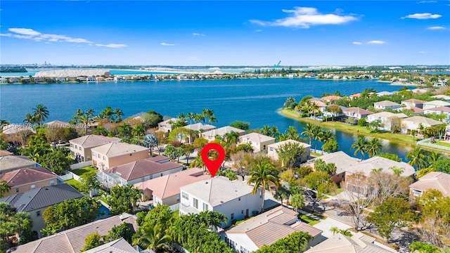 drone / aerial view with a water view and a residential view