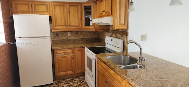 14195 SW 87th St Unit B306, Miami, FL 33183 - kitchen with white appliances, under cabinet range hood, a sink, brown cabinets, and light stone countertops