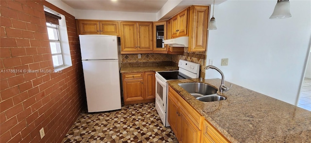 14195 SW 87th St Unit B306, Miami, FL 33183 - kitchen featuring white appliances, a sink, under cabinet range hood, light stone countertops, and brown cabinetry