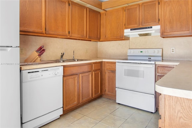 2572 Lakeview Ct, Cooper City, FL 33026 - kitchen with light countertops, light tile patterned floors, a sink, under cabinet range hood, and white appliances
