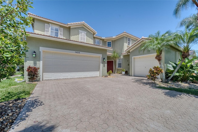 1454 Newhaven Point Ln, West Palm Beach, FL 33411 - view of front of property with stucco siding, decorative driveway, and a tiled roof
