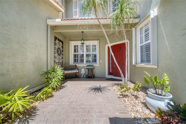1454 Newhaven Point Ln, West Palm Beach, FL 33411 - view of exterior entry with stucco siding and covered porch