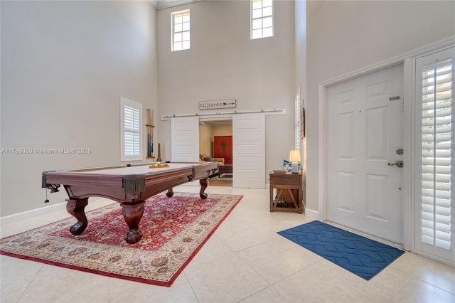 1454 Newhaven Point Ln, West Palm Beach, FL 33411 - rec room with a barn door, a high ceiling, billiards table, and tile patterned floors