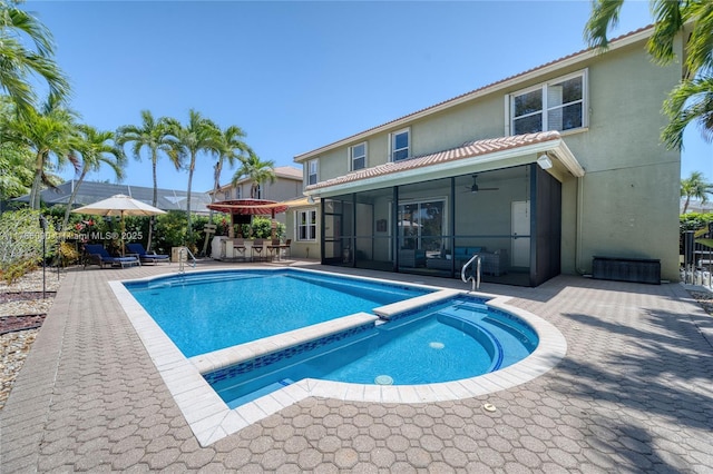 1454 Newhaven Point Ln, West Palm Beach, FL 33411 - view of pool with a sunroom, ceiling fan, a pool with connected hot tub, a patio, and outdoor dining space