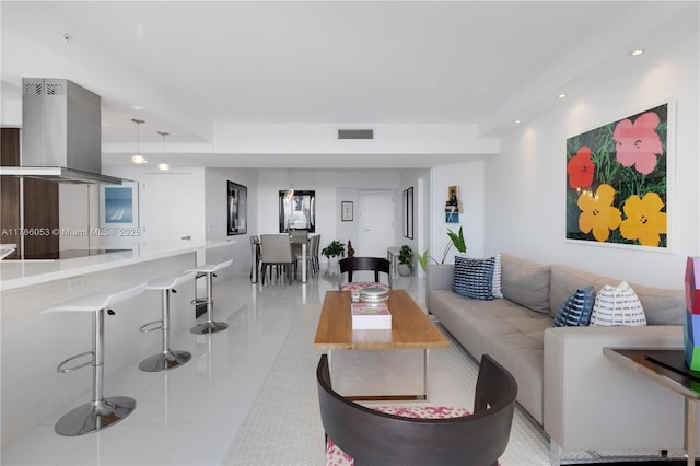 living room featuring visible vents, tile patterned flooring, and recessed lighting