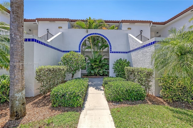 6121 SE Landing Way Unit 13, Stuart, FL 34997 - view of front facade featuring stucco siding and a tile roof