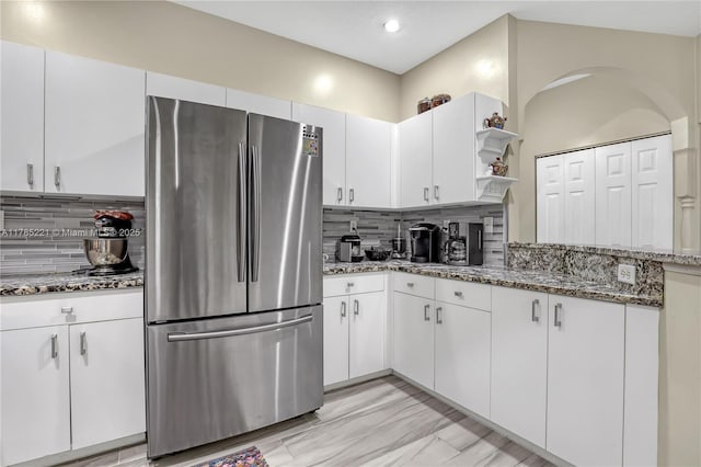 6121 SE Landing Way Unit 13, Stuart, FL 34997 - kitchen featuring freestanding refrigerator, decorative backsplash, open shelves, dark stone counters, and recessed lighting