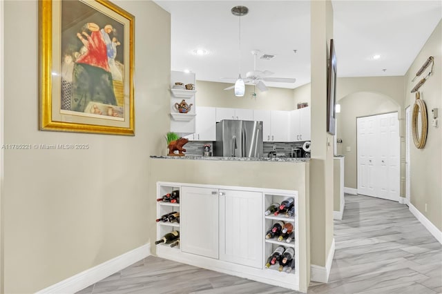 6121 SE Landing Way Unit 13, Stuart, FL 34997 - kitchen with freestanding refrigerator, a ceiling fan, baseboards, white cabinetry, and recessed lighting