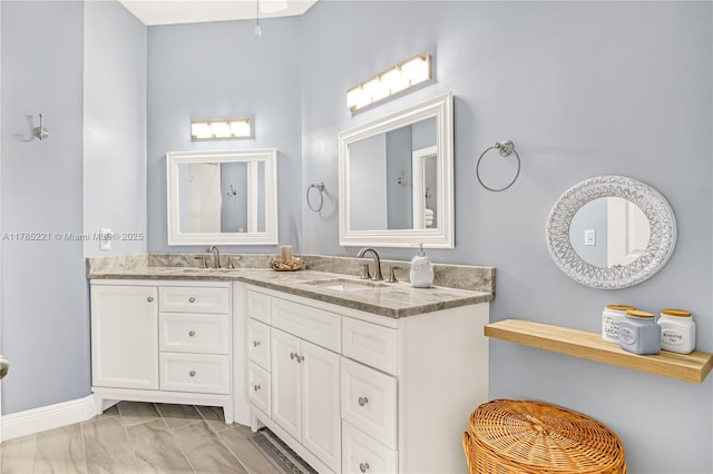 6121 SE Landing Way Unit 13, Stuart, FL 34997 - bathroom featuring double vanity and marble finish flooring