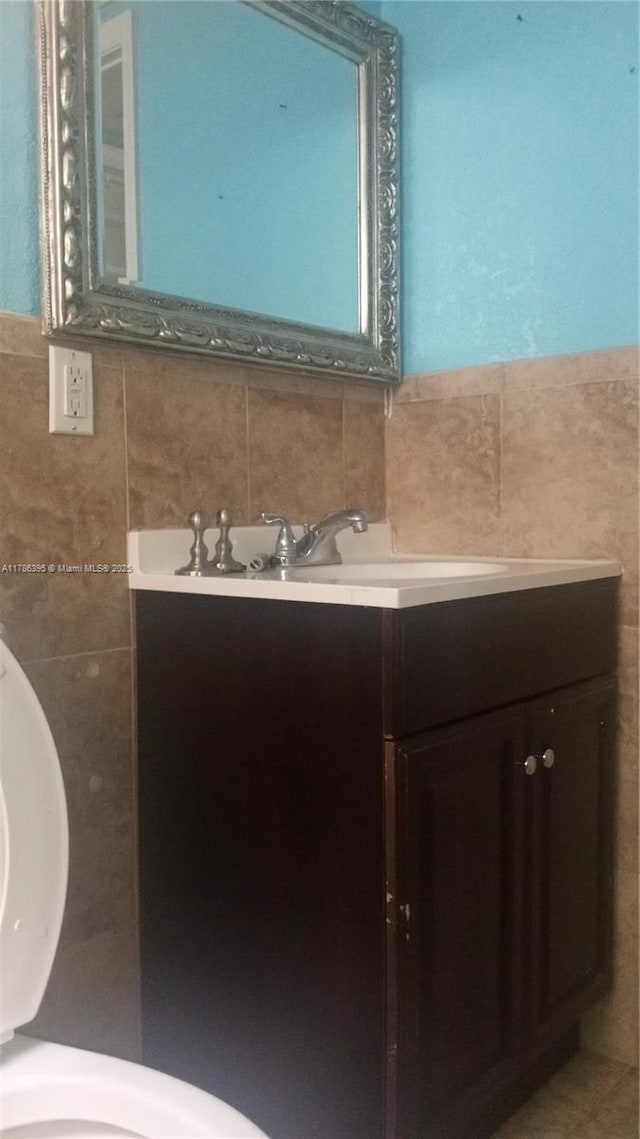 1950 Biarritz Dr Unit 1, Miami Beach, FL 33141 - bathroom featuring tile walls, vanity, and tasteful backsplash
