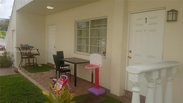 1950 Biarritz Dr Unit 1, Miami Beach, FL 33141 - entrance to property with stucco siding and a patio area