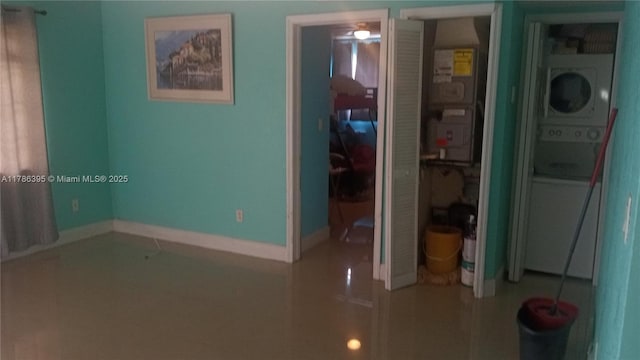 1950 Biarritz Dr Unit 1, Miami Beach, FL 33141 - unfurnished room with estacked washer and dryer, tile patterned floors, and baseboards