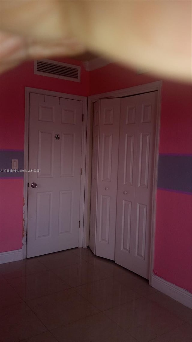 1950 Biarritz Dr Unit 1, Miami Beach, FL 33141 - unfurnished bedroom with baseboards, a closet, and light tile patterned floors